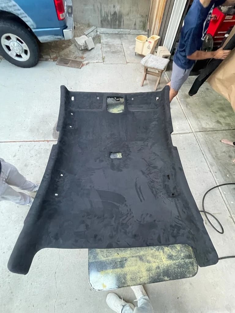Black suede headliner laid out for installation